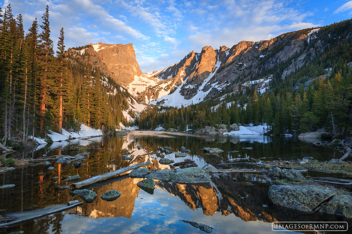 A calm morning at Dream Lake creates a near perfect reflection of Hallett Peak and Flattop Mountain in the early morning light...